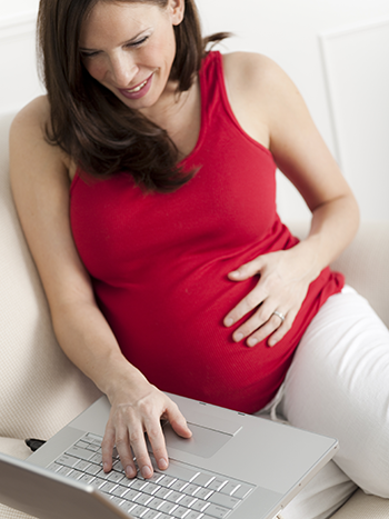 Pregnant woman using a laptop