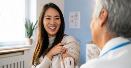 Doctor holding a small gauze on a female patient's upper arm