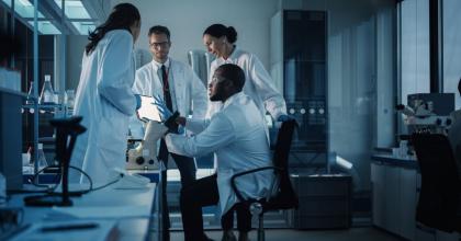 Medical science laboratory with diverse multi-ethnic team of microbiology scientists have meeting on developing drugs, medicine, doing biotechnology research, working on computers, analyzing samples