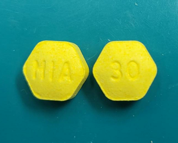 Image of tablets of Zenzedi 30 mg, light yellow hexagonal tablet debossed with “30” on one side and “MIA” on the other side