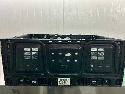 “Image of black plastic crate holding cucumbers”