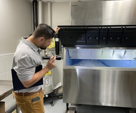 Investigator with the FDA, checking an ice maker for aircraft usage