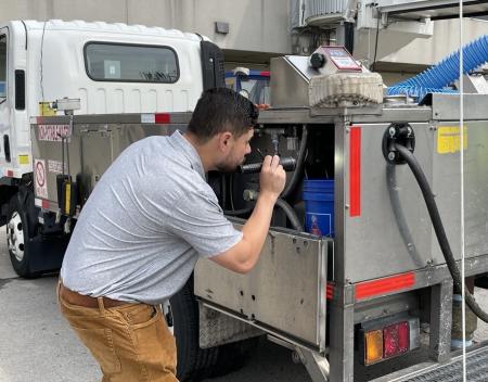 An investigator with the FDA inspecting a watertruck for aircraft usage